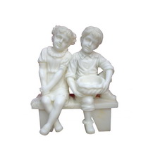 boy and girl on bench statue